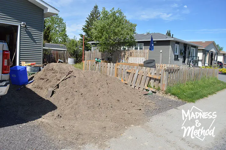 pile of dirt in stone driveway