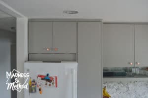 small removable panel above fridge