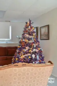 purple christmas tree in basement