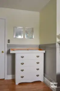 white dresser against grey wainscoting and light yellow walls