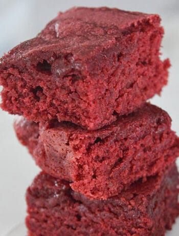 stack of three red velvet brownies on white background