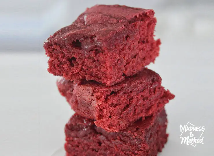stack of three red velvet brownies on white background
