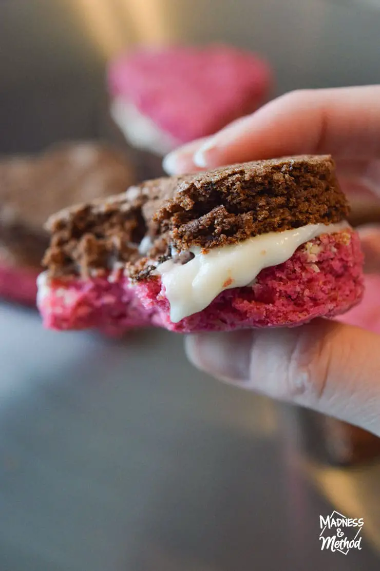 closeup of brownie sandwich with cream cheese frosting and red velvet layer