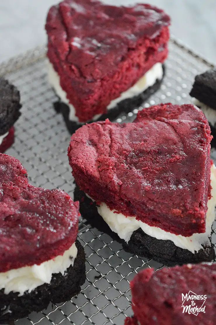 tray of red velvet heart shaped brownies with frosting