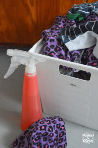 bin of rags and pink spray bottle