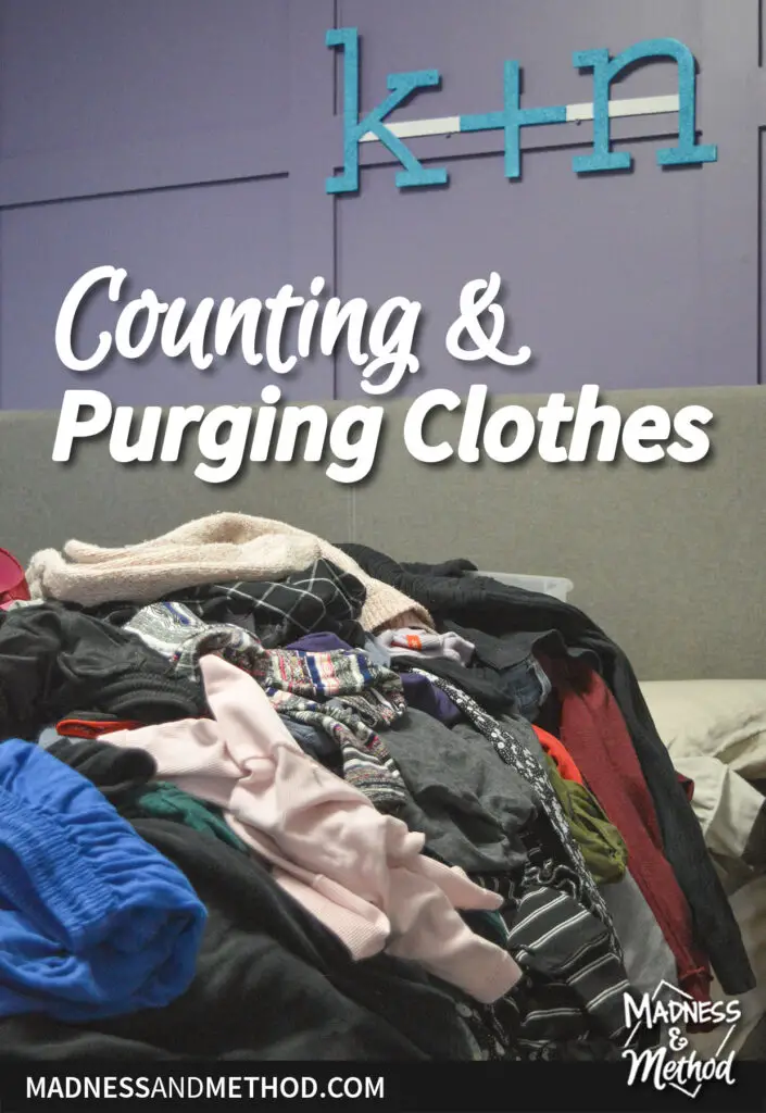 pile of clothes on bed with purple walls