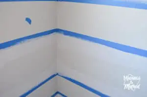 painting base coat on blue painters tape white walls