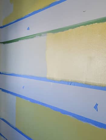 adding darker yellow paint to striped walls