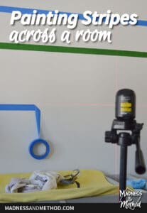 painting stripes across a room text overlay with white walls and laser level