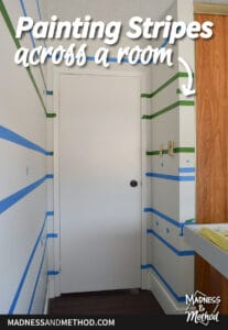 painting stripes across a room text overlay on white door and painters tape stripes
