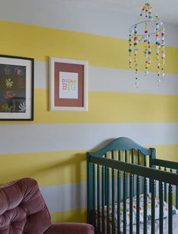 yellow white striped walls green crib
