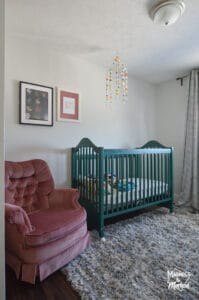 green crib pink chair white walls