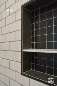 black shower niche white subway tile walls