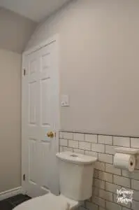 white subway tile behind toilet