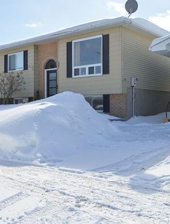 raised ranch house with lots of snow