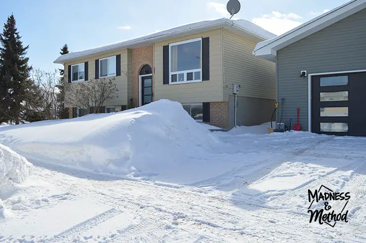 raised ranch house with lots of snow