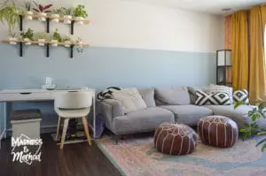 living room office combo with light blue walls and gray couch