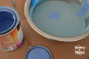 mixing blue paint in metal bowl