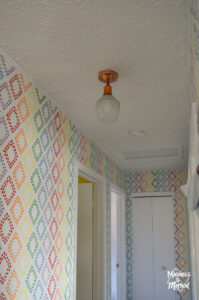 copper light fixture white ceilings and rainbow walls