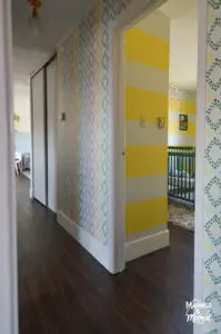 yellow striped bedroom near hallway