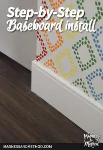 white baseboard with rainbow stencil wall