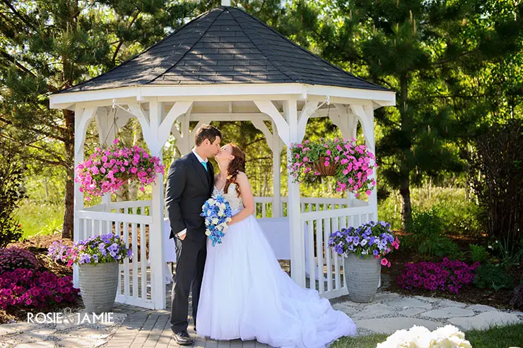 wedding bride and groom under gazebo outdoors