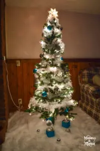 christmas tree with lights in panelled basement