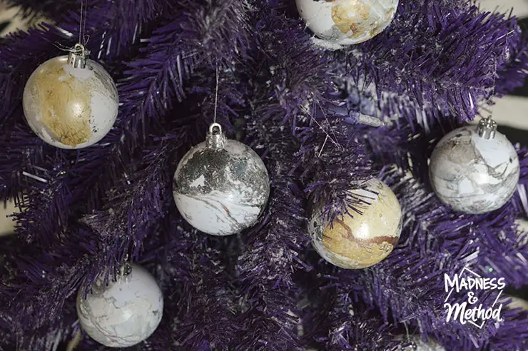 marble look ornaments on purple tree