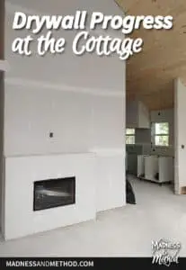 drywall progress at the cottage text overlay with fireplace