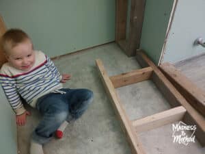 toddler next to shower ledge