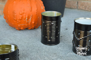 black tin can lantern with pumpkin