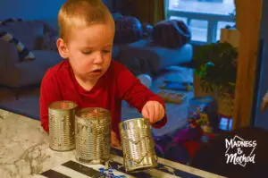 toddler decorating tin can lantern