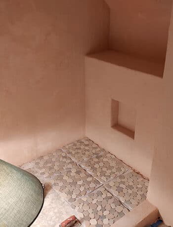 peach microcement walls in shower nook