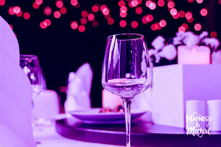 wine glass on table with purple background