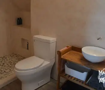microcement walls white toilet wood vanity