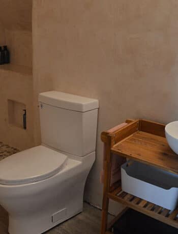 microcement walls white toilet wood vanity