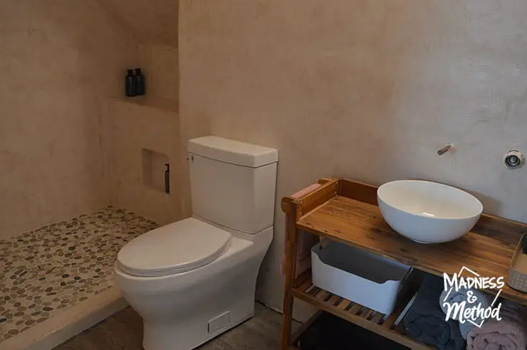 microcement walls white toilet wood vanity