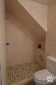 microcement shower walls and rock tiles