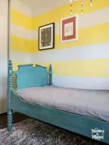 yellow white striped walls teal bed