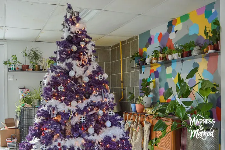 purple christmas tree near colouful wall