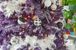 purple christmas tree with black and white ornaments