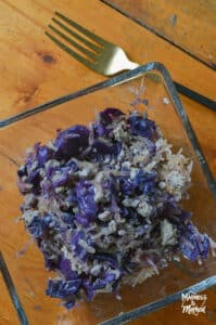 wood table with clear bowl and fried purple cabbage