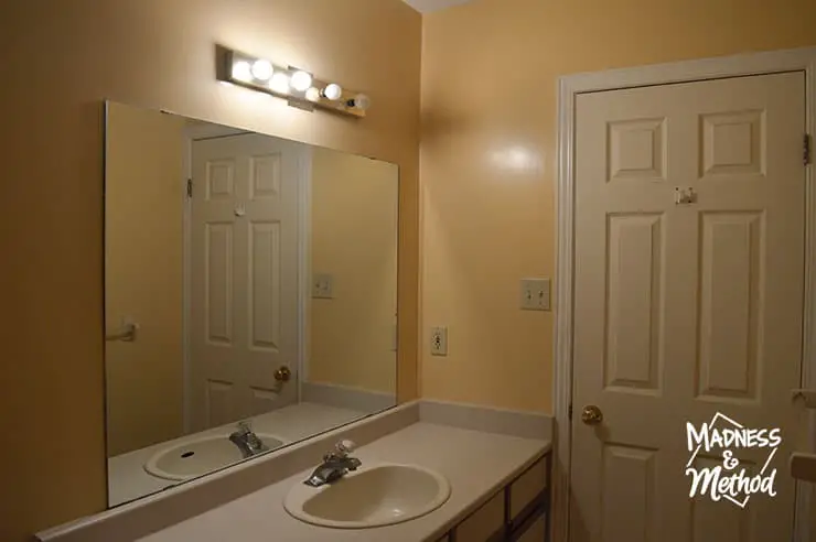 beige bathroom mirror and lights