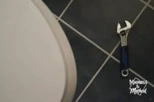 wrench on ground near toilet