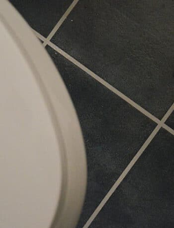 wrench on ground near toilet