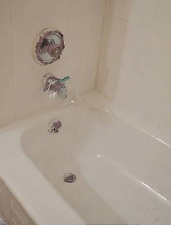 white painted bathtub and tiles