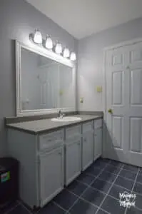 white vanity with gray walls and gray counters