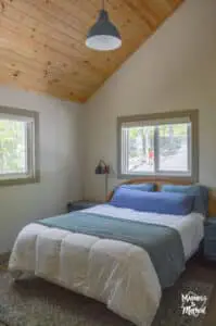 blue bedding white duvet bed with wood ceiling