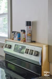 over the stove shelf between windows