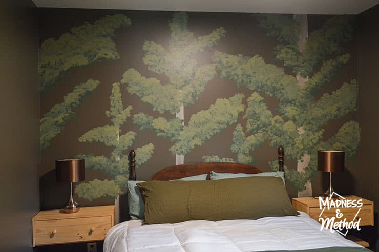 pine tree mural behind bed